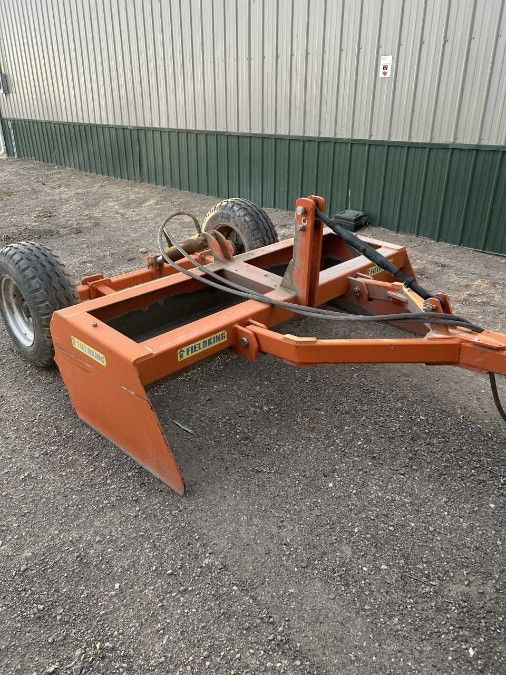 Front load tractor with drag box
